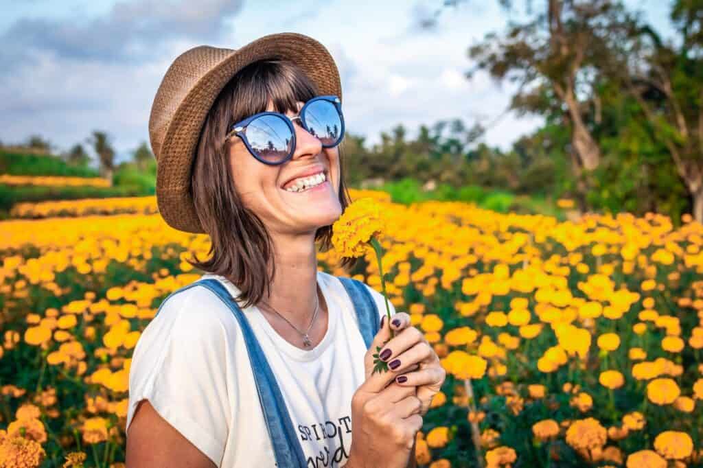 woman smiling in flowerfield